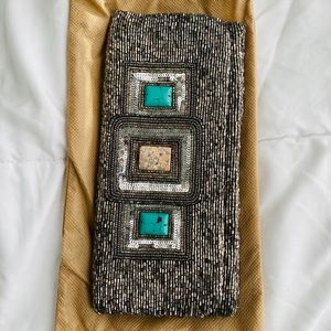 Moyna from CUSP silver clutch